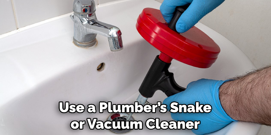 Use a Plumber’s Snake or Vacuum Cleaner