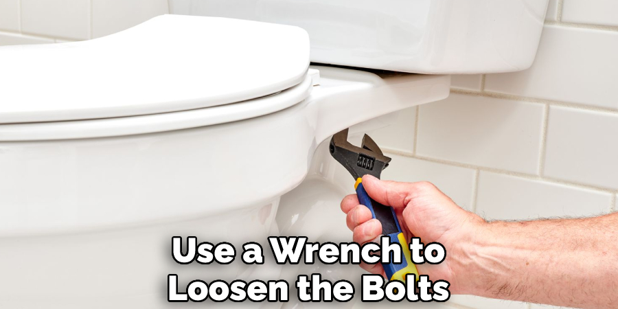 Use a Wrench to Loosen the Bolts