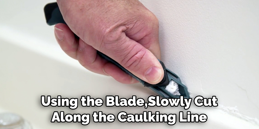 Using the Blade, Slowly Cut Along the Caulking Line