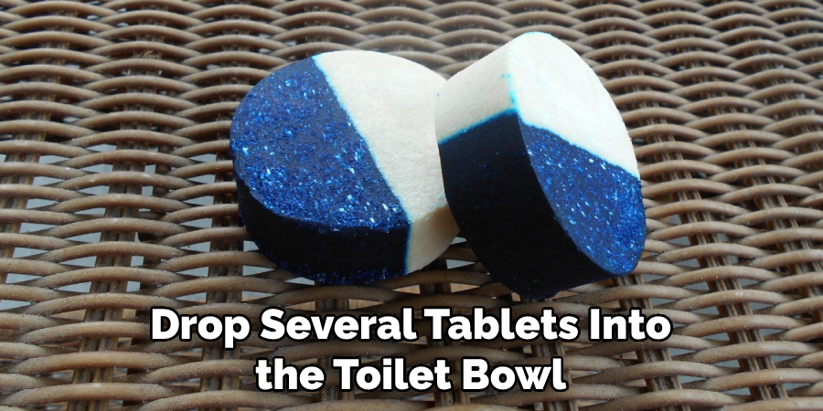 Drop Several Tablets Into the Toilet Bowl