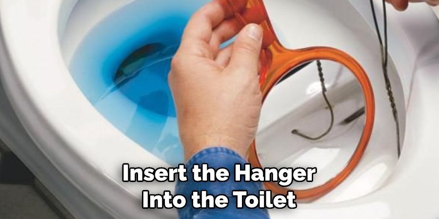 Insert the Hanger Into the Toilet