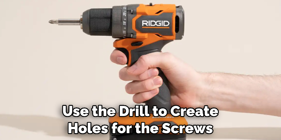 Use the drill to create holes for the screws