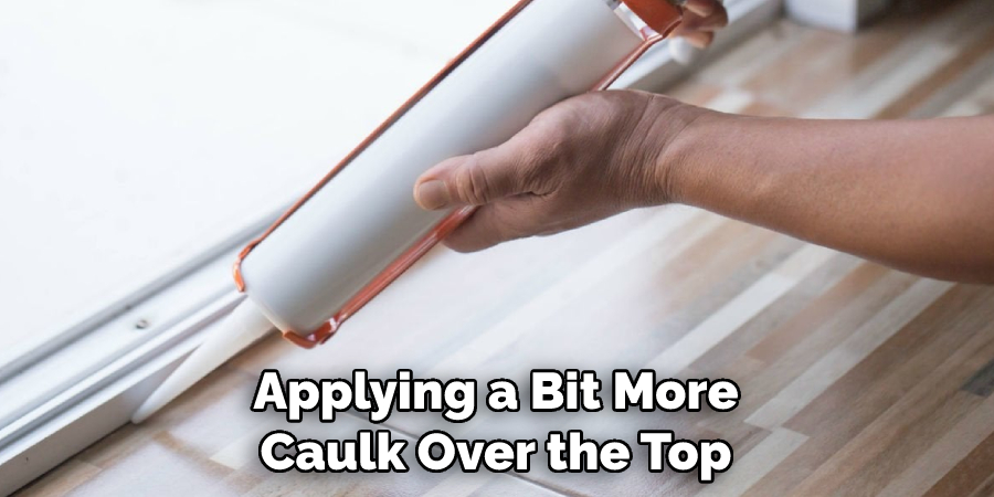 Applying a Bit More Caulk Over the Top