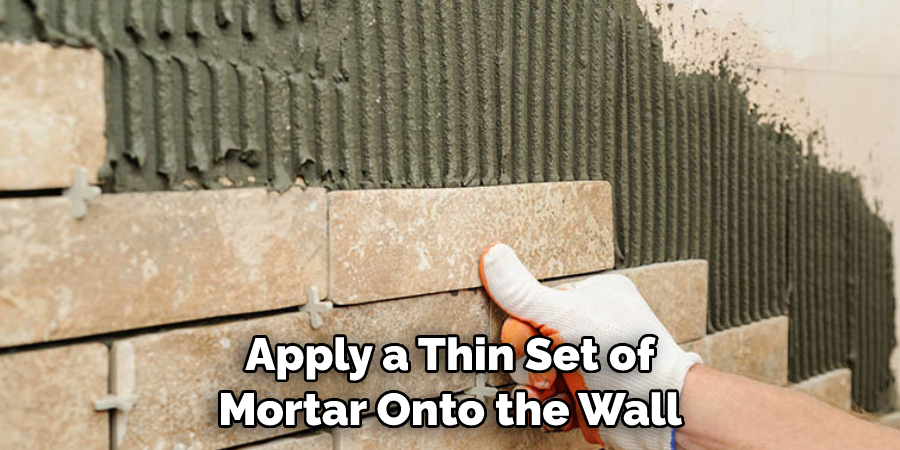 Apply a Thin Set of Mortar Onto the Wall