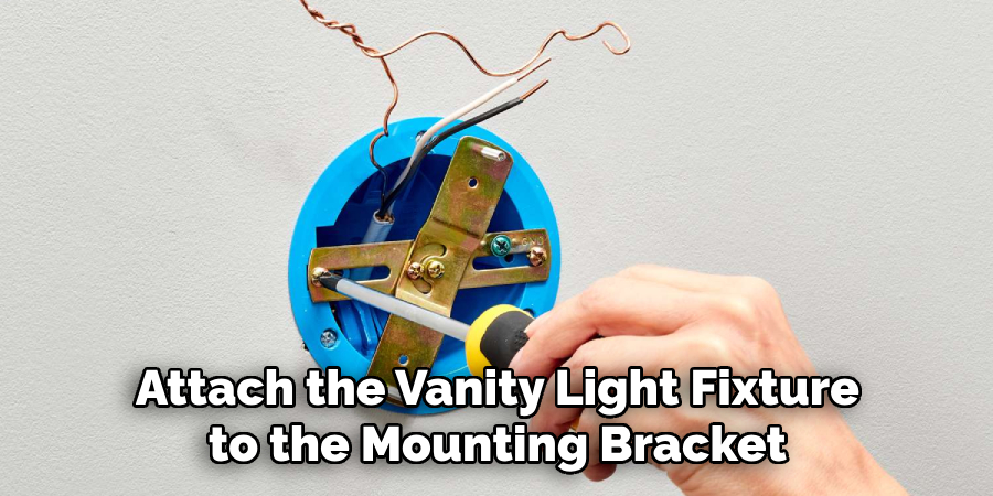 attach the vanity light fixture to the mounting bracket