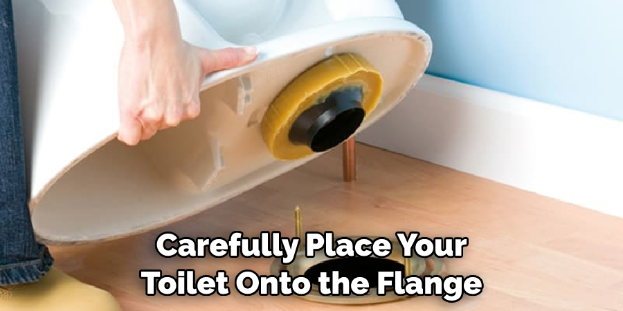 Carefully Place Your Toilet Onto the Flange