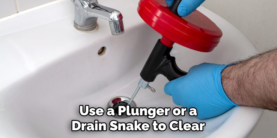 Use a Plunger or a Drain Snake to Clear