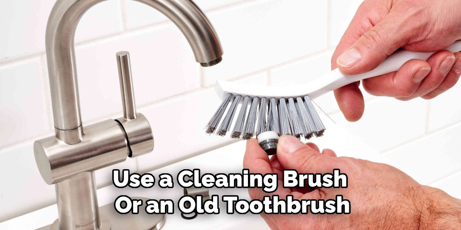 Use a Cleaning Brush 
Or an Old Toothbrush