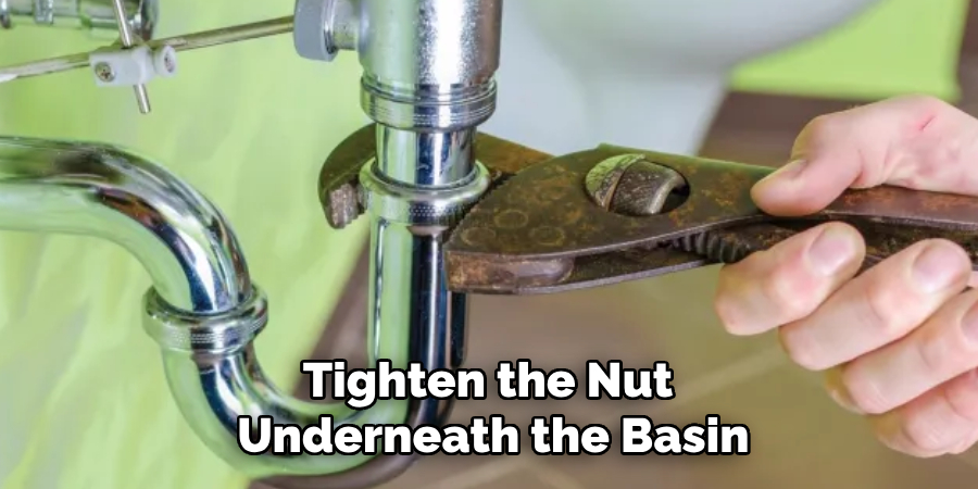 Tighten the Nut 
Underneath the Basin