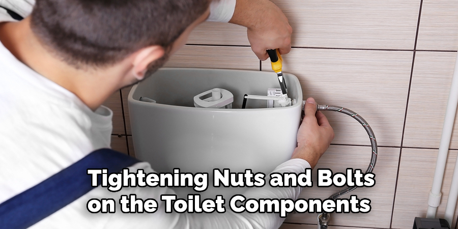 tightening nuts and bolts on the toilet components