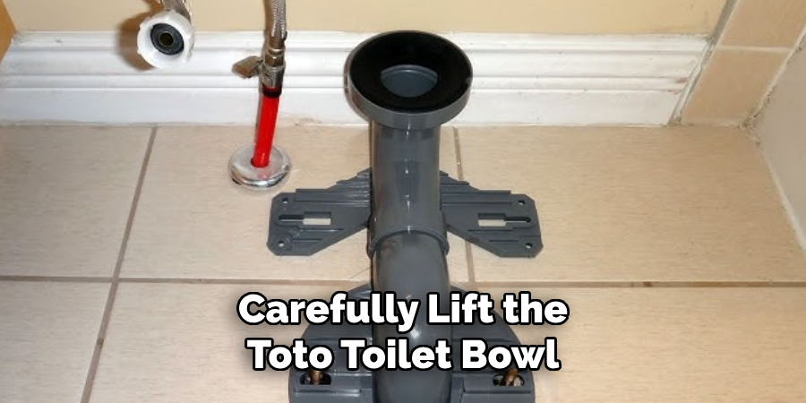 Carefully Lift the Toto Toilet Bowl