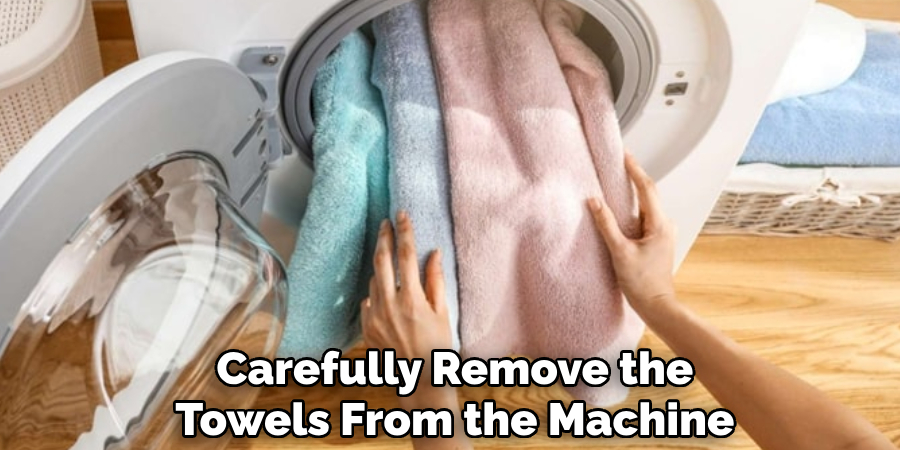 carefully remove the towels from the machine