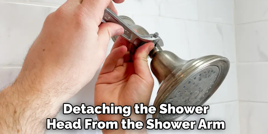 detaching the shower head from the shower arm