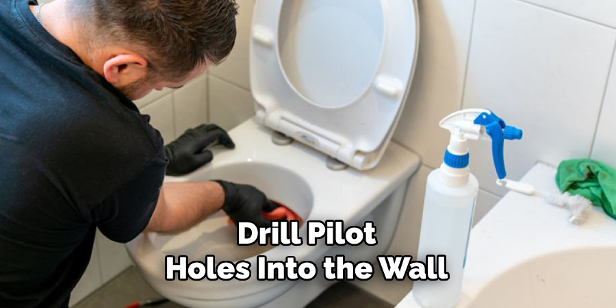 Drill Pilot Holes Into the Wall