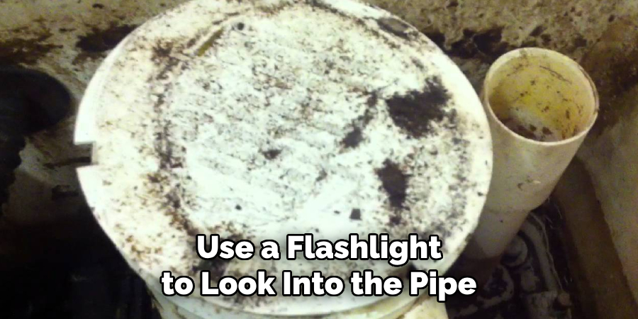 Use a Flashlight to Look Into the Pipe