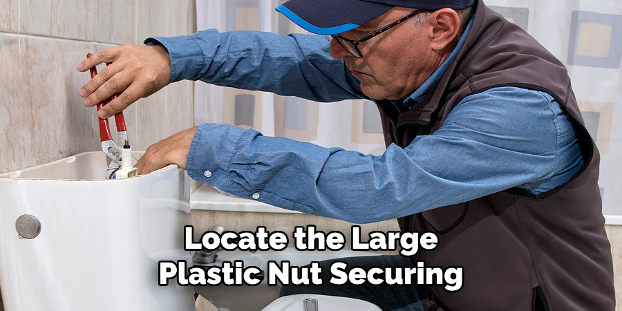locate the large plastic nut securing
