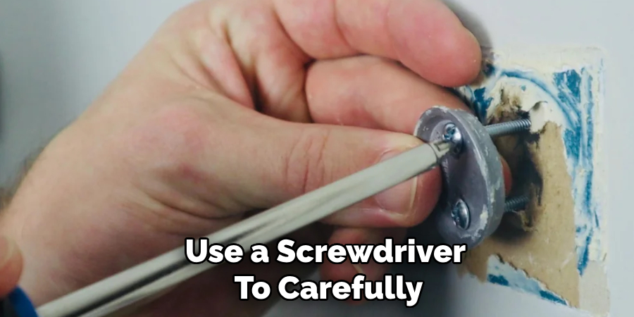 Use a Screwdriver
To Carefully